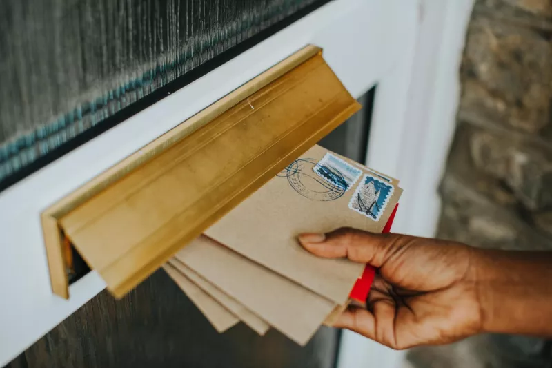 Woman picking up mail 1