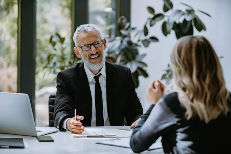 Happy mature man formalwear having business meeting with employee modern office 1